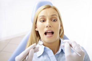 Scared woman sitting in dentist chair